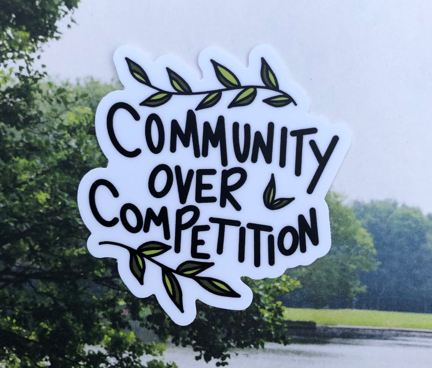 Community over competition sticker